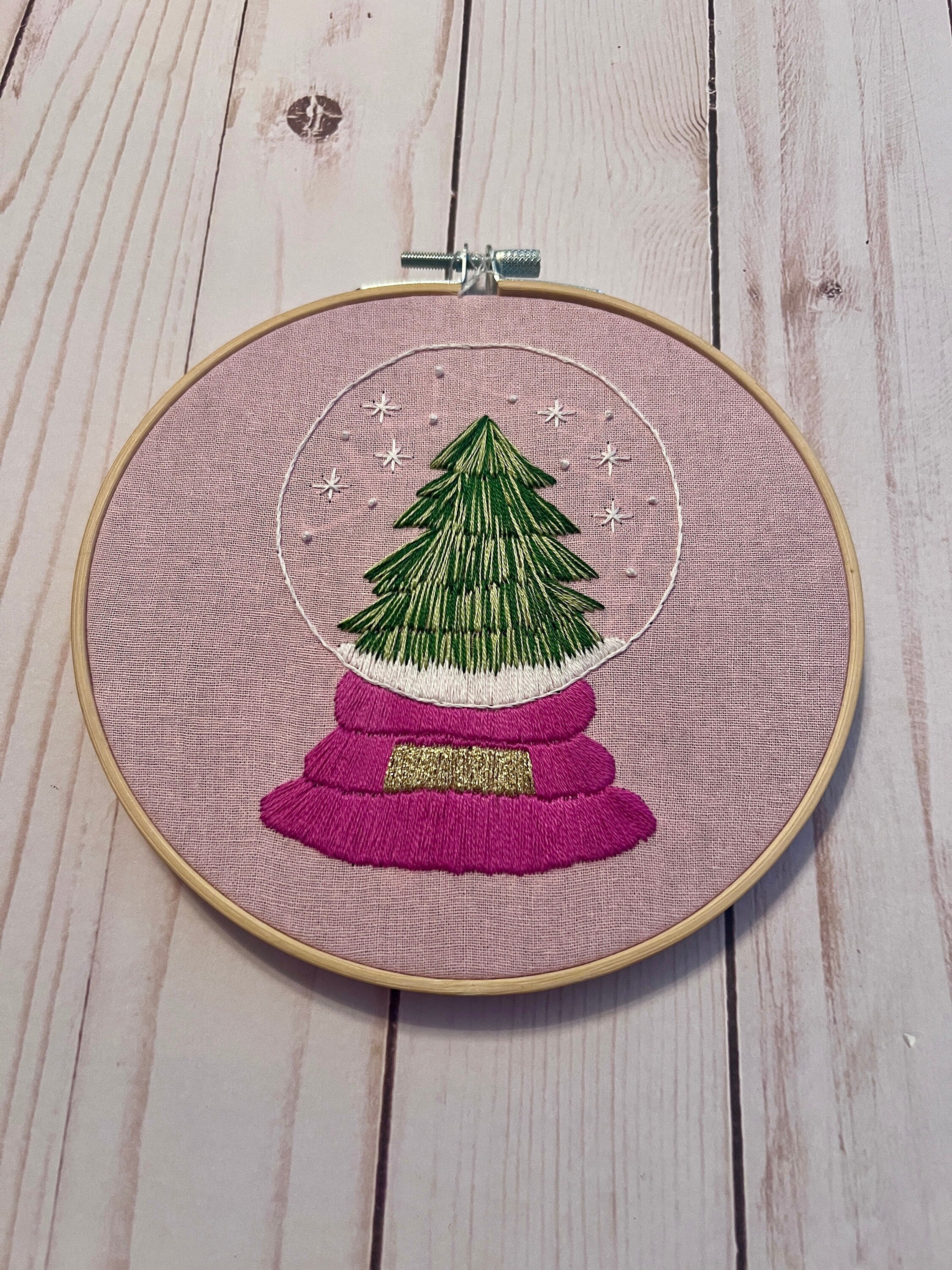 Christmas Tree Snow Globe Finished Embroidery Hoop on Pink Fabric