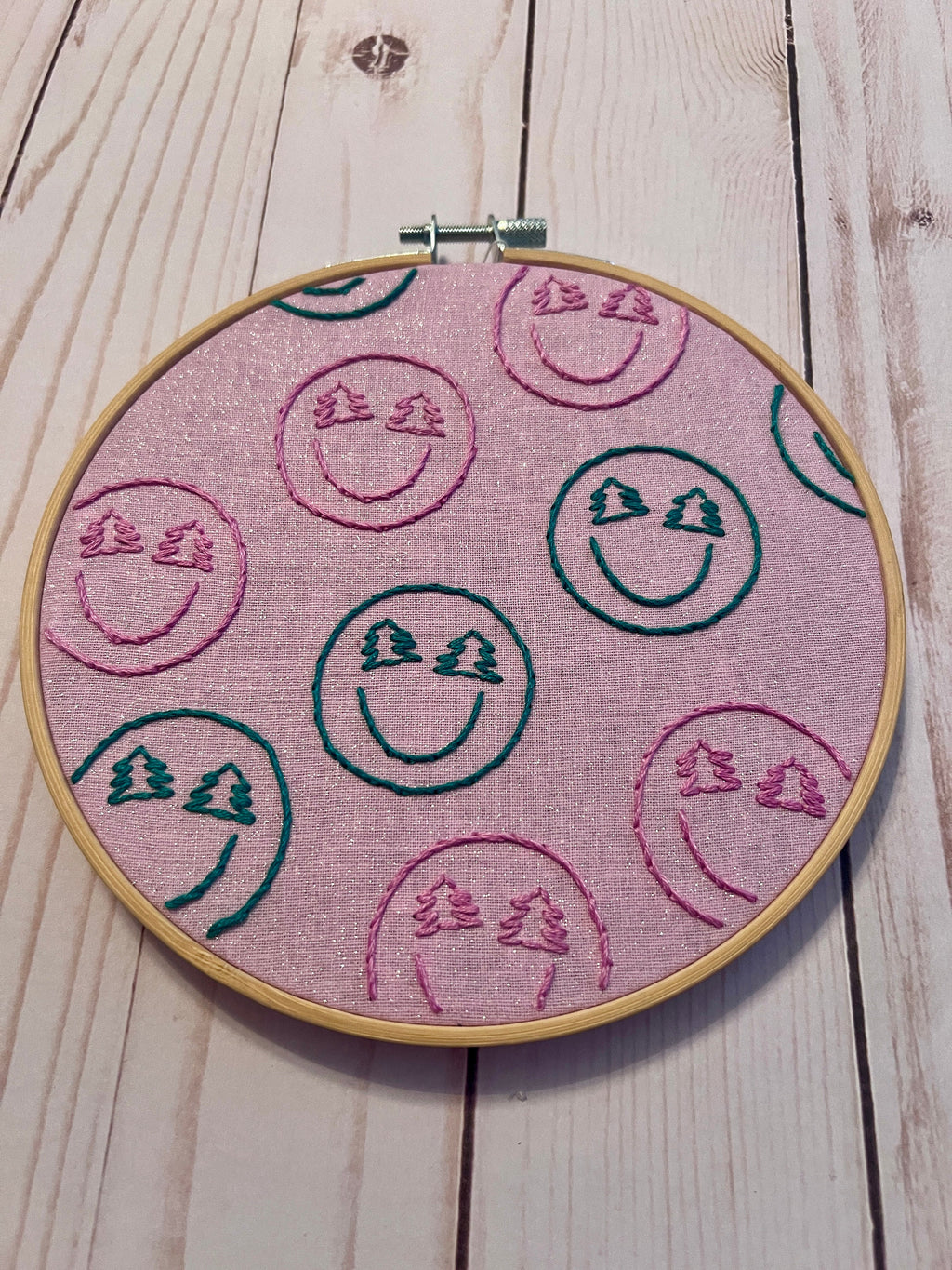 Christmas-y Smiley Faces Finished Embroidery Hoop on Pink Fabric