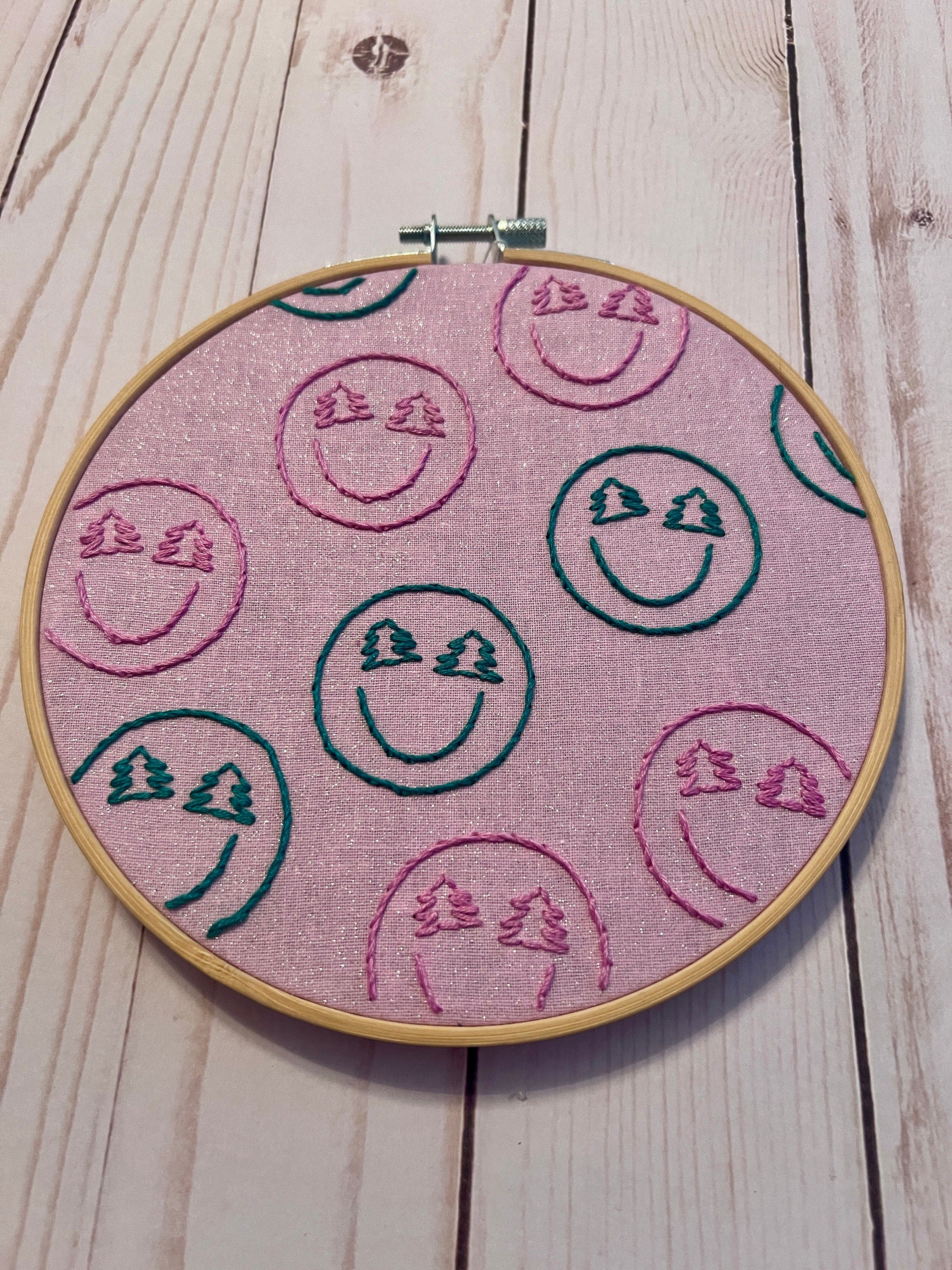 Christmas-y Smiley Faces Finished Embroidery Hoop on Pink Fabric