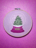 Christmas Tree Snow Globe Finished Embroidery Hoop on Pink Fabric